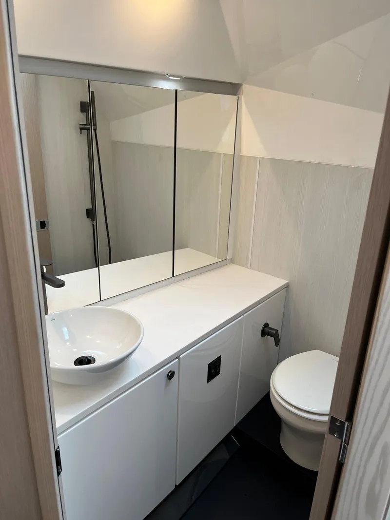 Slide: The Image of Modern bathroom in 2022 Fairline F//Line 33 yacht with sleek fixtures and mirrored cabinet. - 24