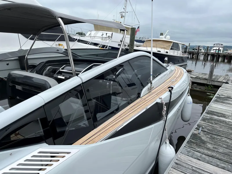 Slide: The Image of 2022 Fairline F//Line 33 yacht docked at marina, sleek design, luxury boat. - 4