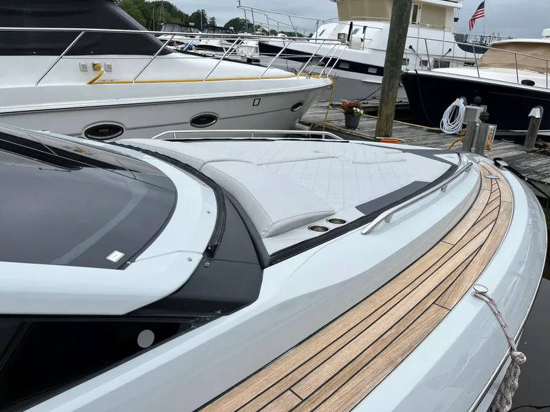 Slide: The Image of 2022 Fairline F//Line 33 yacht with sleek design and wooden deck at marina. - 5