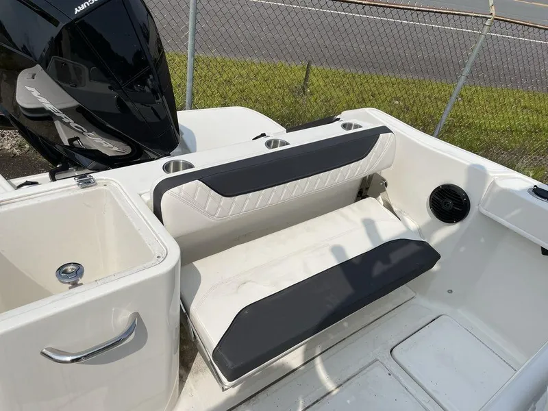 Slide: The Image of 2023 Bayliner Trophy 24 CC boat interior with seating and motor. - 1