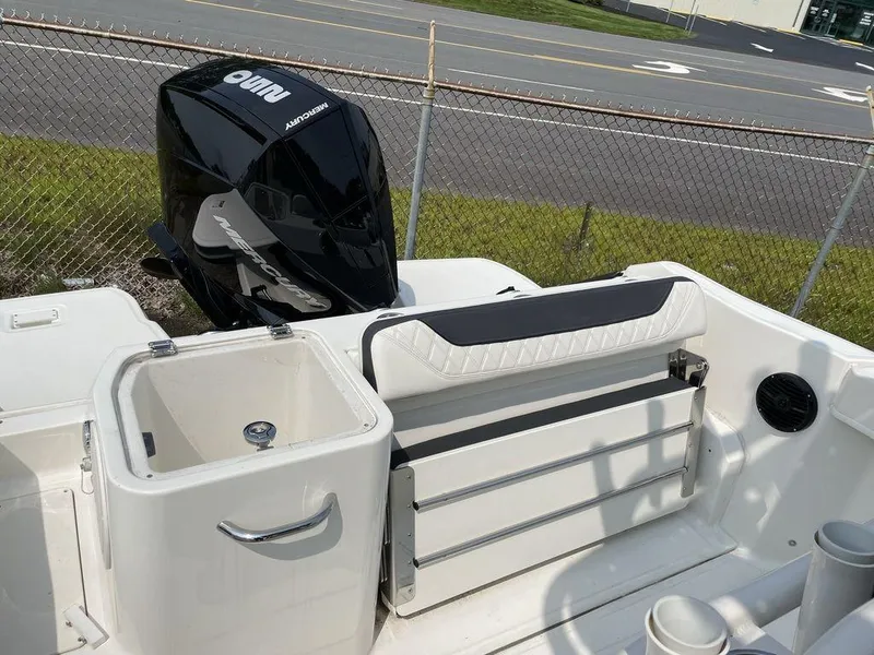 Slide: The Image of 2023 Bayliner Trophy 24 CC boat with outboard motor and seating area. - 10