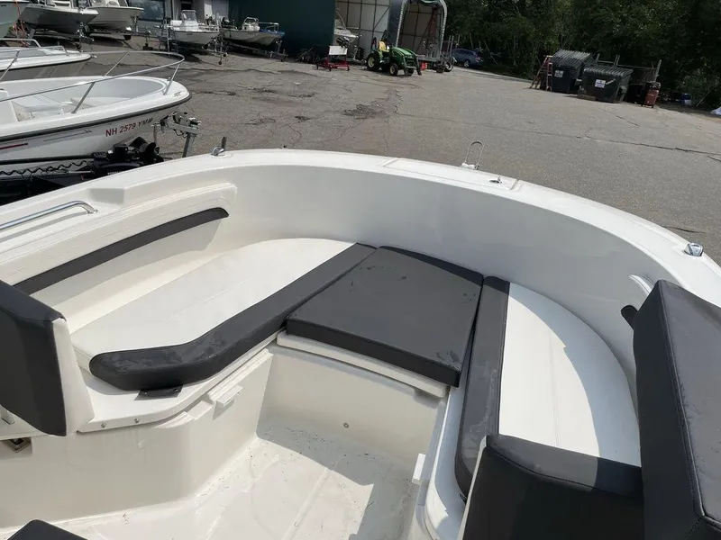 Slide: The Image of 2023 Bayliner Trophy 24 CC boat interior with cushioned seating. - 7