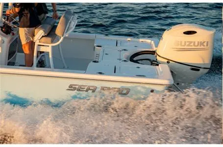 Slide: The Image of 2023 Sea Pro 208 Bay Boat with T-Top and Suzuki outboard motor on water. - 3