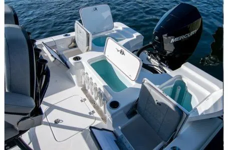 Slide: The Image of 2023 Sea Pro 208 Bay Boat with T-Top, open storage compartments, and Mercury outboard engine. - 4