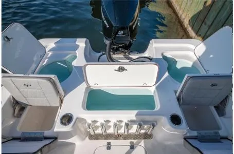 Slide: The Image of 2023 Sea Pro 208 Bay Boat with T-Top, rear view showing storage compartments and motor. - 8