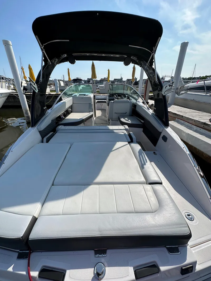 Slide: The Image of 2017 Regal Fasdeck RX boat with spacious seating and sunshade at the dock. - 2