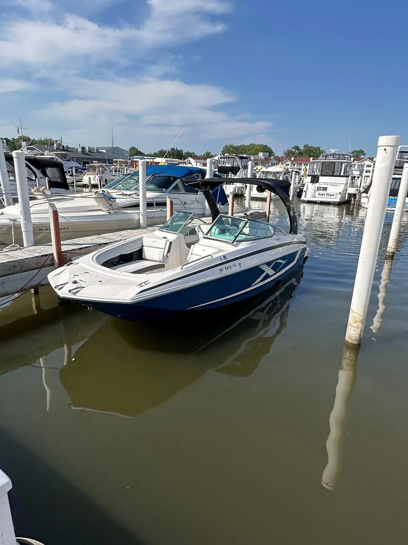 Slide: The Image of 2017 Regal Fasdeck RX boat docked at a marina on a sunny day. - 3