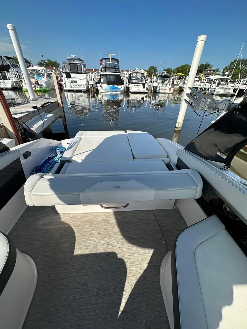 Slide: The Image of 2017 Regal Fasdeck RX boat docked at a marina with other boats. - 4
