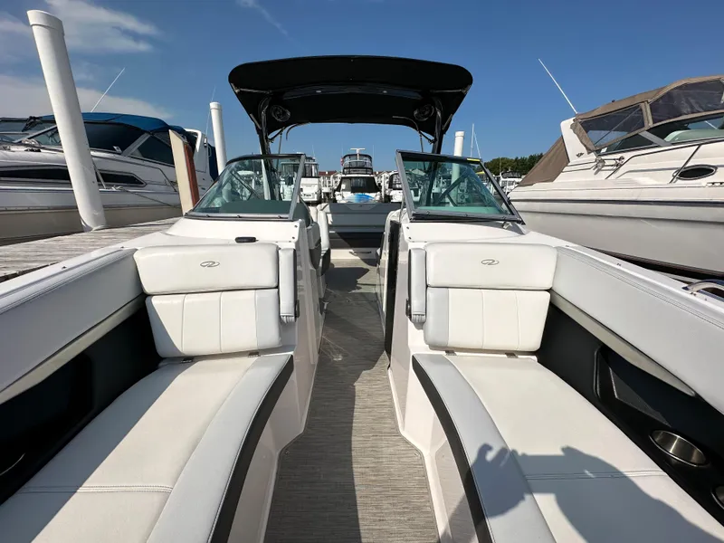 Slide: The Image of 2017 Regal Fasdeck RX boat interior at marina with white seating. - 5