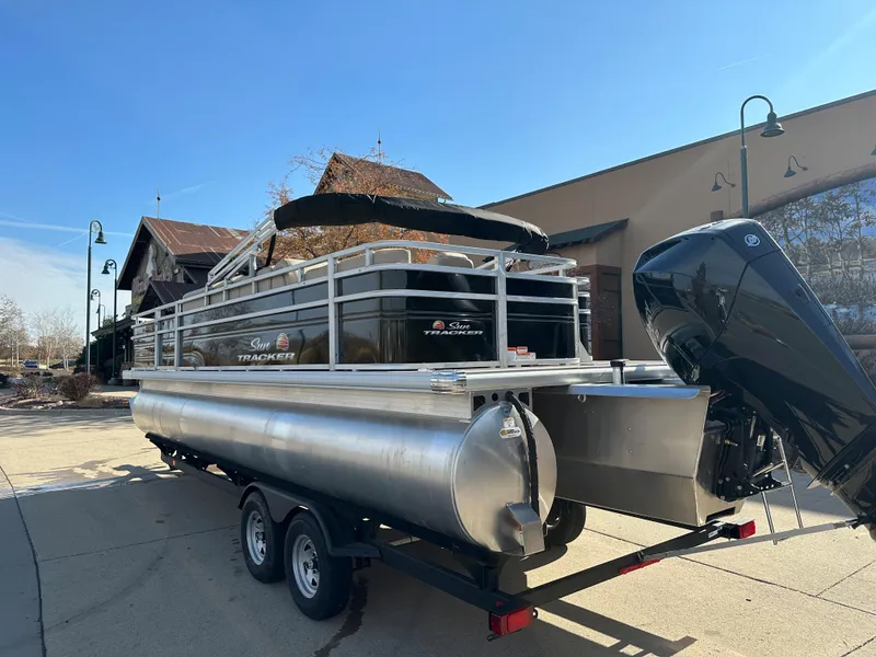 Slide: The Image of 2024 Sun Tracker Sportfish 24 XP3 pontoon boat on a trailer. - 2