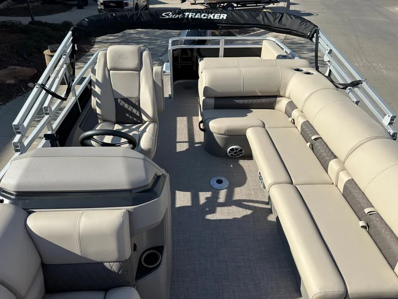 Slide: The Image of 2024 Sun Tracker Sportfish 24 XP3 pontoon boat interior with beige seating. - 3