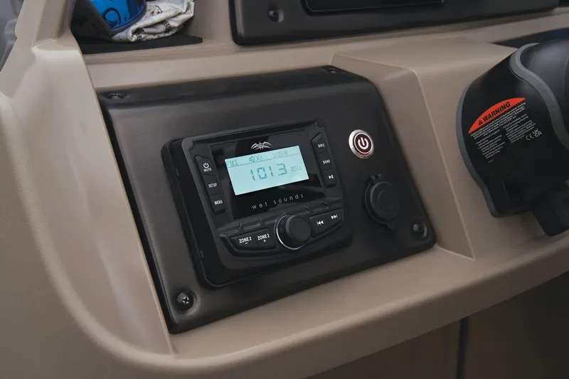 Slide: The Image of 2024 Sun Tracker Sportfish 24 XP3 boat dashboard with radio and control panel. - 43