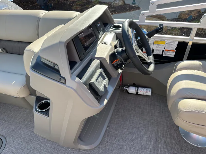 Slide: The Image of 2024 Sun Tracker Sportfish 24 XP3 boat helm with steering wheel and control panel. - 5