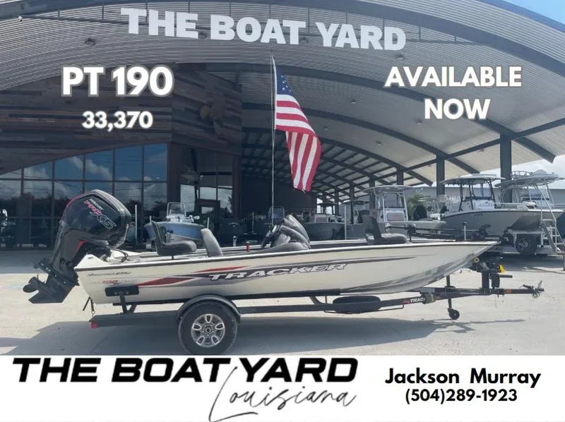 The Image of 2024 Tracker Pro Team 190 TX boat with Mercury engine, parked in a marina. - 0