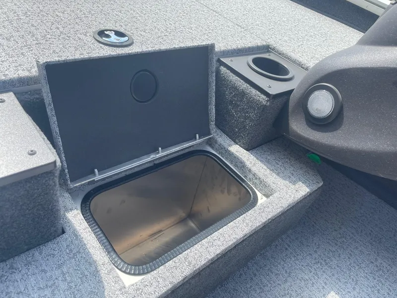 Slide: The Image of 2024 Tracker Pro Team 190 TX boat interior with steering wheel and seating. - 13