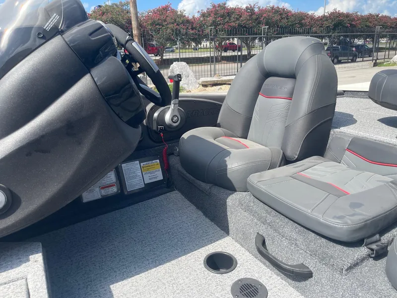 Slide: The Image of 2024 Tracker Pro Team 190 TX boat deck with seating and storage compartments. - 15