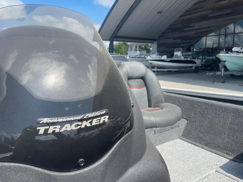 Slide: The Image of 2024 Tracker Pro Team 190 TX boat storage compartment with cup holder and speaker. - 16