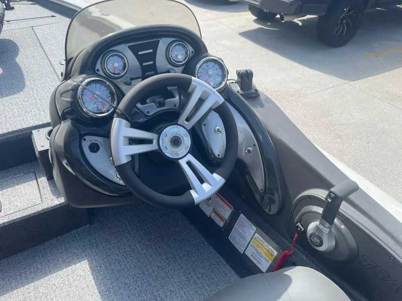 Slide: The Image of 2024 Tracker Pro Team 190 TX boat with Minn Kota trolling motor in a dealership lot. - 17