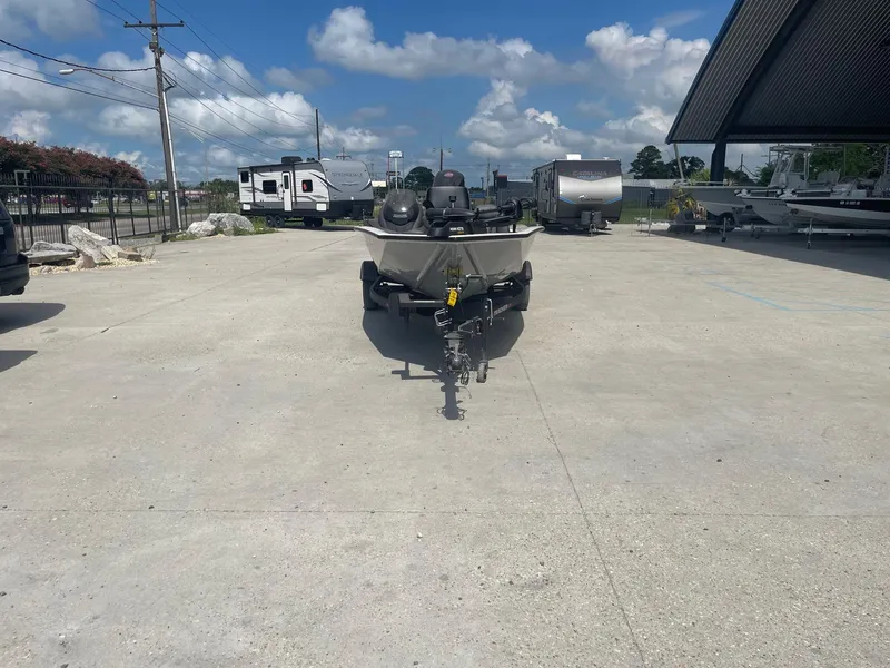 Slide: The Image of 2024 Tracker Pro Team 190 TX boat on trailer, parked outdoors under a sunny sky. - 2