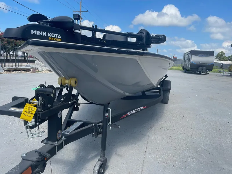 Slide: The Image of 2024 Tracker Pro Team 190 TX boat interior with NOCO Genius charger and storage compartment. - 21