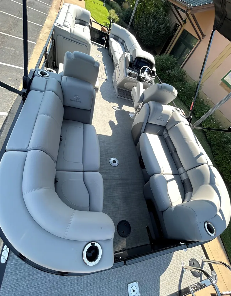 Slide: The Image of 2024 Regency 250 LE3 pontoon boat with spacious seating and modern design. - 11