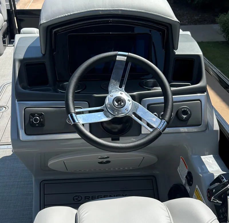 Slide: The Image of 2024 Regency 250 LE3 boat steering console with modern controls and sleek design. - 13