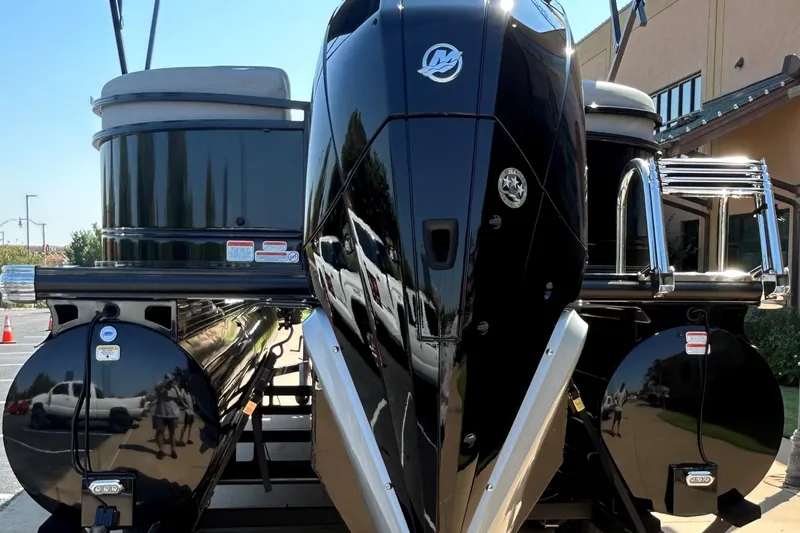 Slide: The Image of 2024 Regency 250 LE3 pontoon boat, sleek black design, docked outdoors. - 4