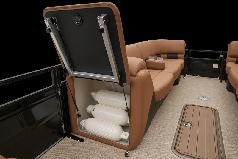 Slide: The Image of 2024 Regency 250 LE3 boat interior with storage compartment and tan seating. - 40