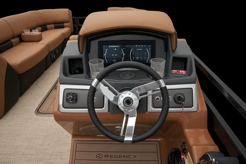 Slide: The Image of 2024 Regency 250 LE3 boat dashboard with steering wheel and digital display. - 49