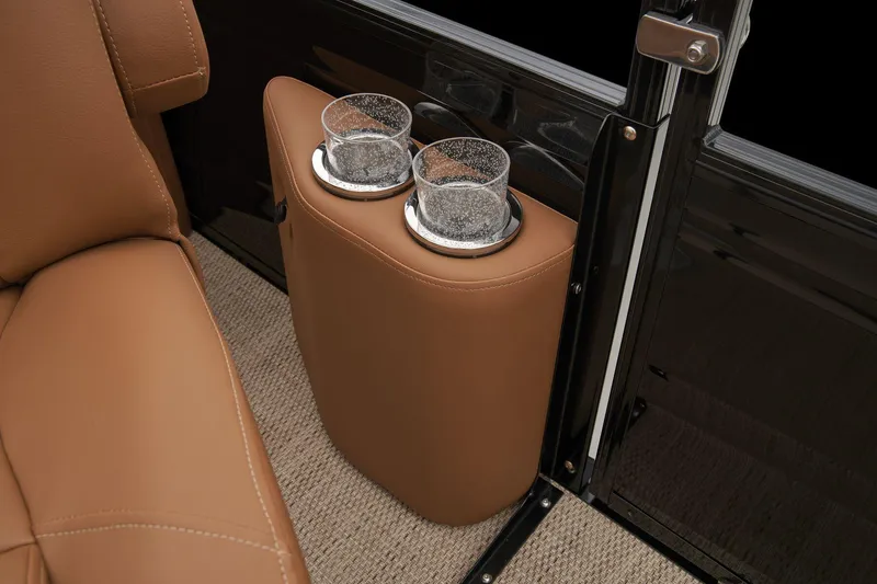 Slide: The Image of 2024 Regency 250 LE3 boat interior with tan leather seats and dual cup holders. - 59