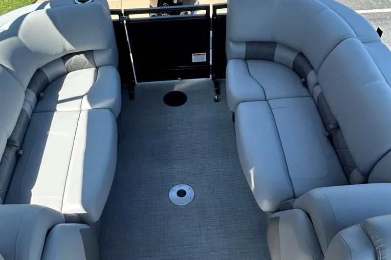 Slide: The Image of 2024 Regency 250 LE3 boat interior with gray seating and carpeted floor. - 7