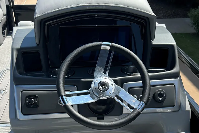 Slide: The Image of Steering wheel of 2024 Regency 250 LE3 boat, featuring modern dashboard design. - 8