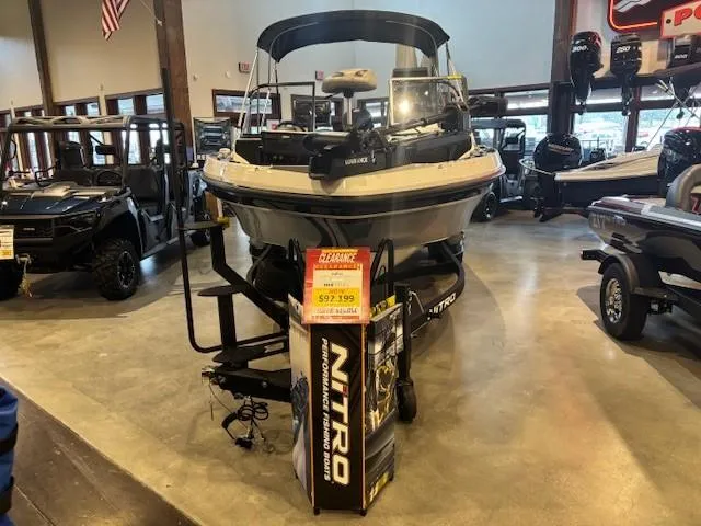 The Image of 2023 Nitro ZV20 Pro boat displayed indoors with sleek design and dual-axle trailer. - 0