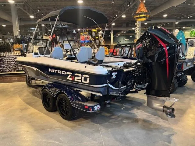 Slide: The Image of 2023 Nitro ZV20 Pro boat displayed indoors with powerful outboard motor. - 2