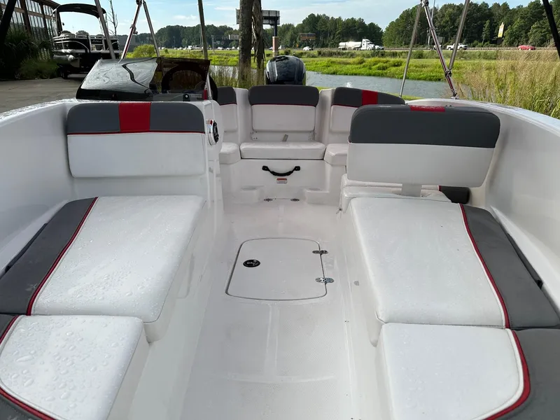 Slide: The Image of 2024 Tahoe T16 boat interior with white and gray seating, red accents, and open deck. - 4