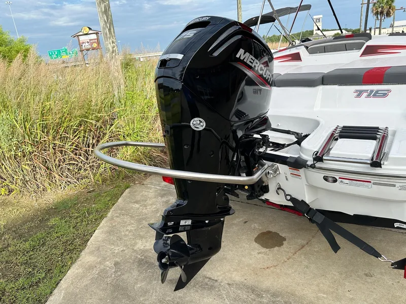 Slide: The Image of 2024 Tahoe T16 boat with Mercury outboard motor, parked on concrete near grass. - 5