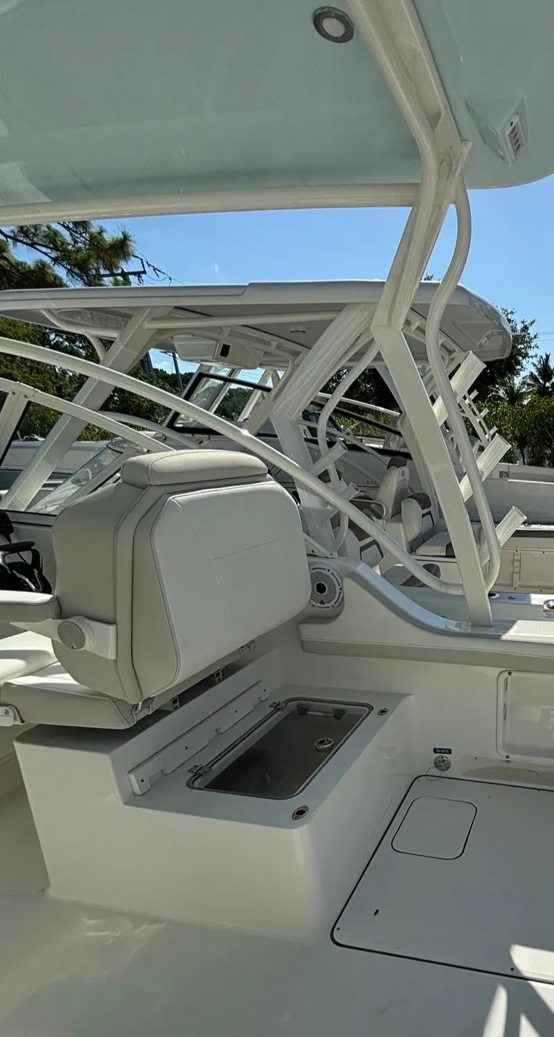 Slide: The Image of 2024 World Cat 296 DC boat interior with seating and storage compartments. - 10