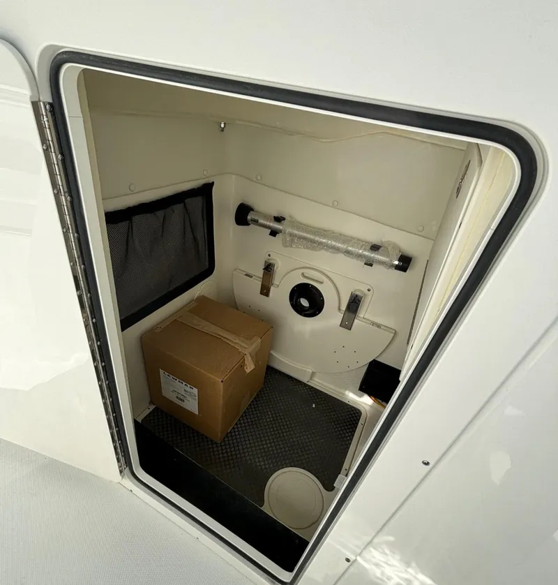 Slide: The Image of 2024 World Cat 296 DC storage compartment with a box inside - 15