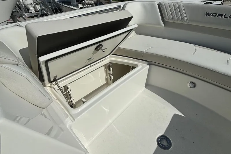 Slide: The Image of 2024 World Cat 296 DC boat with open storage compartment and cushioned seating. - 18