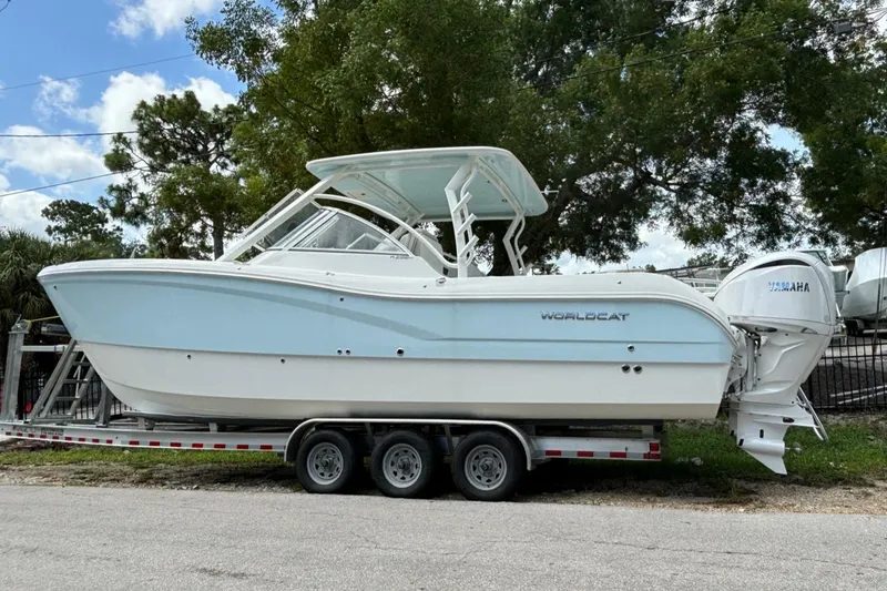 Slide: The Image of 2024 World Cat 296 DC boat on a trailer, side view, with Yamaha engines. - 2