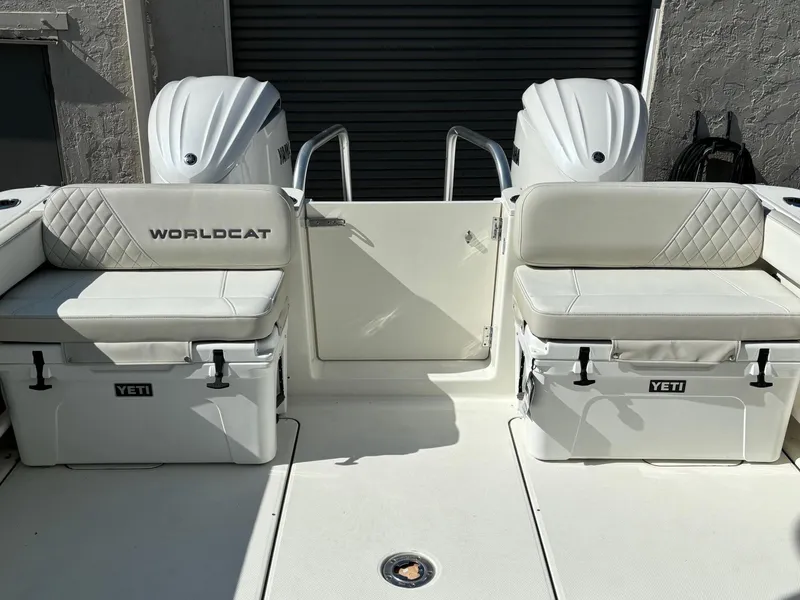 Slide: The Image of 2024 World Cat 296 DC boat with dual Yeti coolers and cushioned seating. - 7