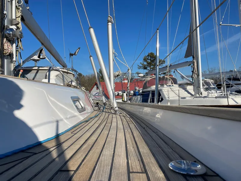 Slide: The Image of 2009 Hallberg-Rassy 54 sailboat deck with clear blue sky background. - 10