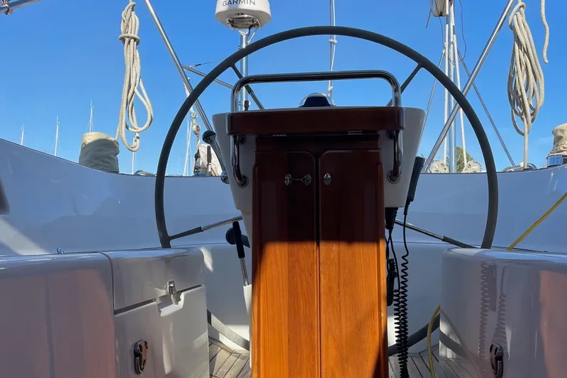 Slide: The Image of Cockpit of 2009 Hallberg-Rassy 54 sailboat with steering wheel and navigation equipment. - 11