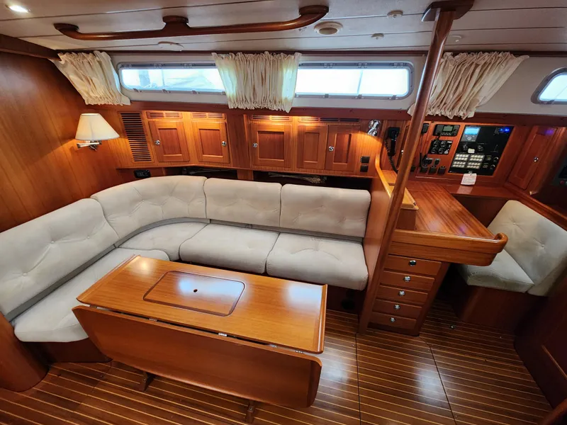 Slide: The Image of Luxurious 2009 Hallberg-Rassy 54 yacht interior with plush seating and elegant wood finishes. - 14