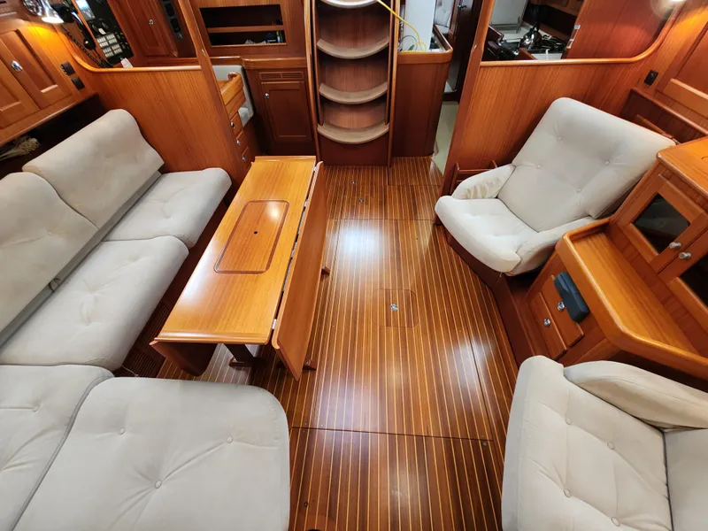 Slide: The Image of Luxurious 2009 Hallberg-Rassy 54 yacht interior with plush seating and elegant wood finish. - 17