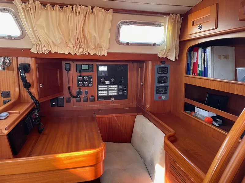 Slide: The Image of Interior of 2009 Hallberg-Rassy 54 yacht with navigation equipment and wooden cabinetry. - 18