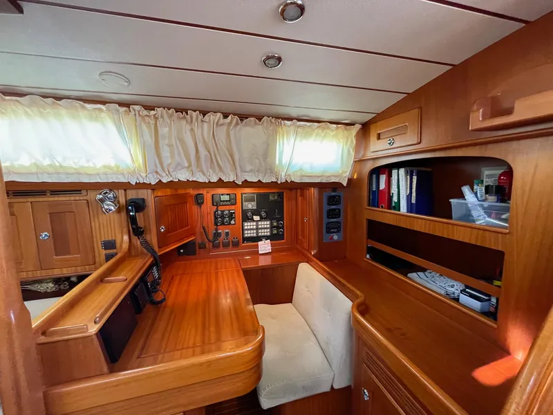 Slide: The Image of Interior of 2009 Hallberg-Rassy 54 yacht with wooden finish and navigation equipment. - 19