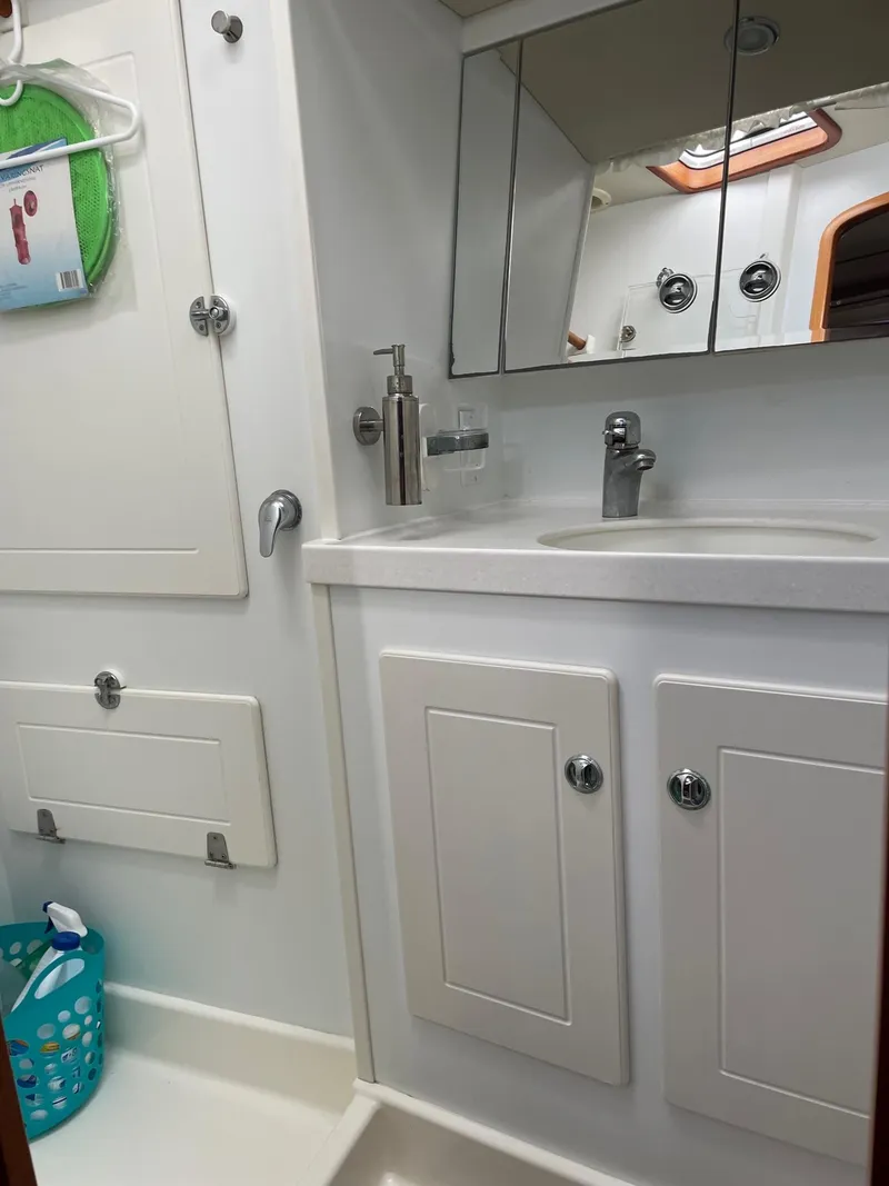 Slide: The Image of 2009 Hallberg-Rassy 54 yacht bathroom with white cabinetry and modern fixtures. - 27