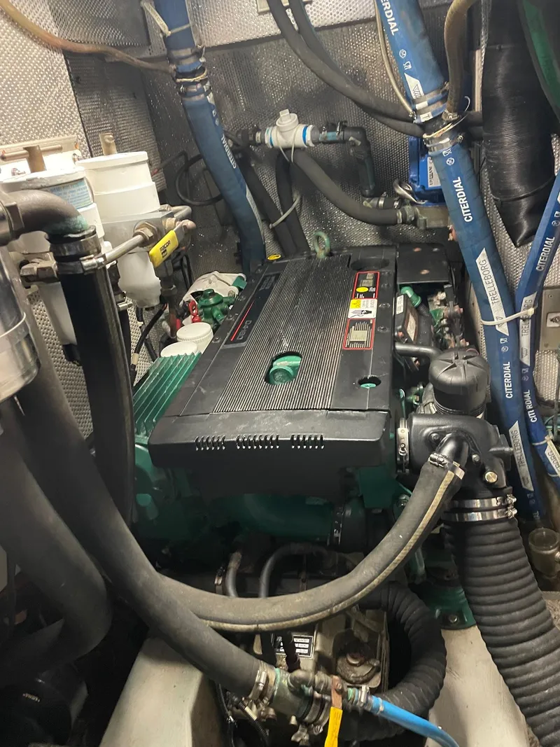 Slide: The Image of Engine room of a 2009 Hallberg-Rassy 54 yacht with visible components and hoses. - 30