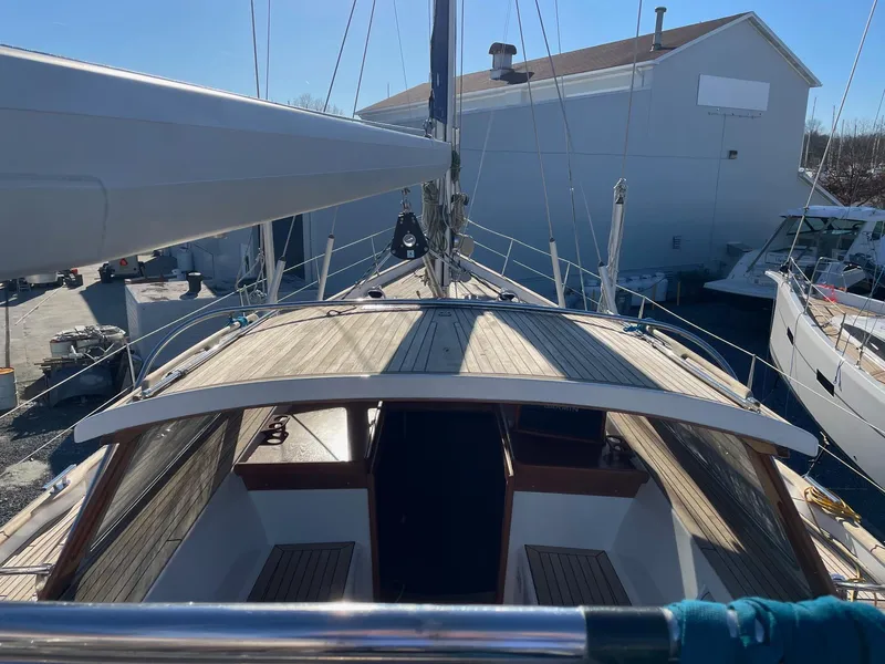 Slide: The Image of 2009 Hallberg-Rassy 54 sailboat docked, showcasing deck and cabin details. - 35